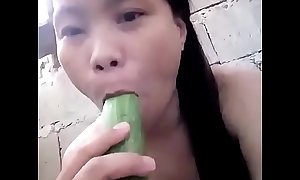Asian masturbating with cucumber