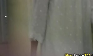 Oriental babe filmed pissing